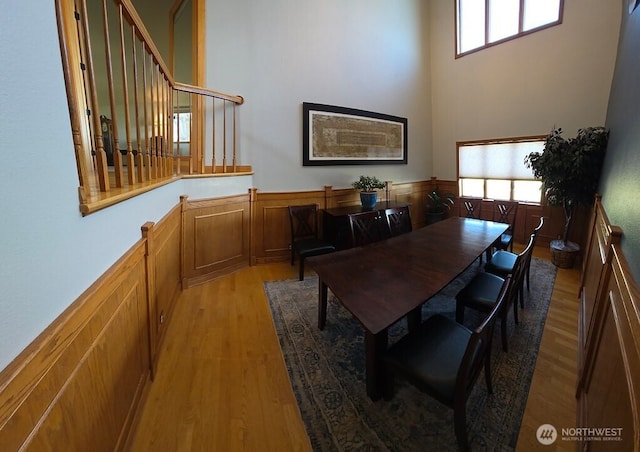 440 W Line Rd, Ephrata, WA 98823 - dining space featuring light wood-type flooring, wainscoting, a high ceiling, and stairway