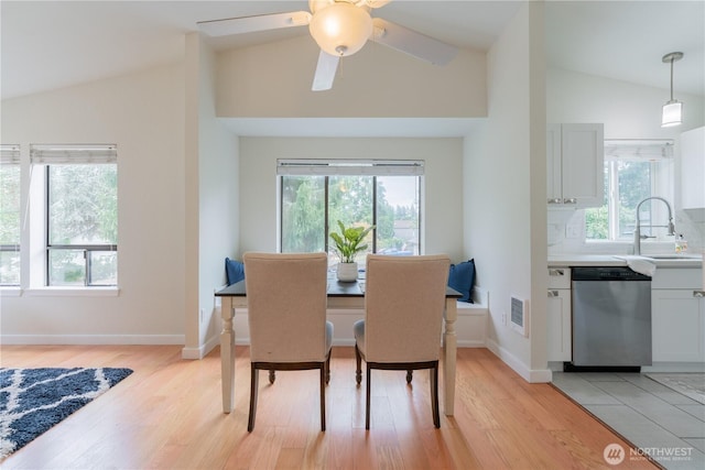 7309 46th Street Ct W, University Place, WA 98466 - dining space with vaulted ceiling, healthy amount of natural light, light wood-style flooring, and a ceiling fan