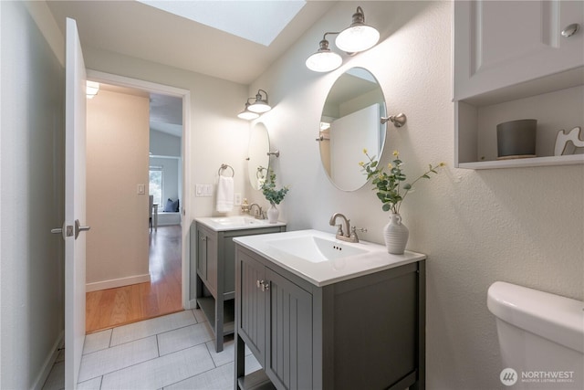 7309 46th Street Ct W, University Place, WA 98466 - bathroom with two vanities, a skylight, and tile patterned floors
