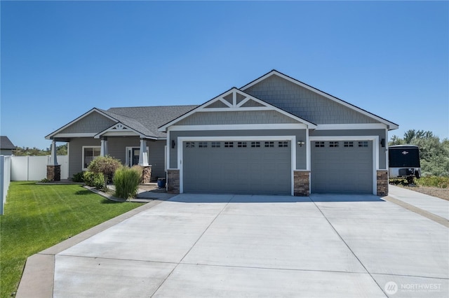 550 N Sparrow Ln, Moses Lake, WA 98837 - craftsman-style home with driveway, a garage, and stone siding