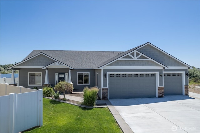 550 N Sparrow Ln, Moses Lake, WA 98837 - craftsman-style house featuring a garage, concrete driveway, stone siding, and roof with shingles