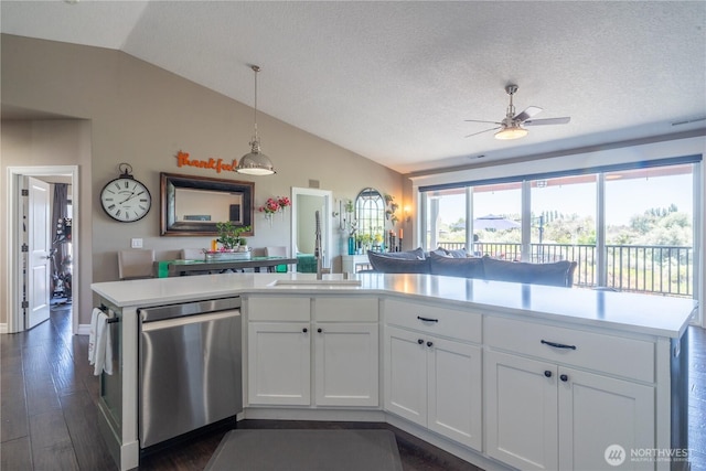 550 N Sparrow Ln, Moses Lake, WA 98837 - kitchen with stainless steel dishwasher, lofted ceiling, a ceiling fan, light countertops, and white cabinets