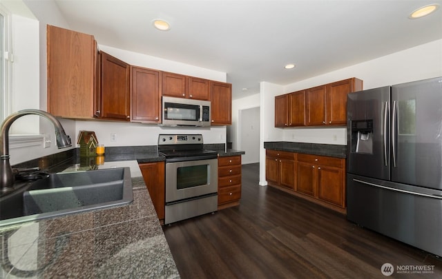 10312 26th Pl SE, Lake Stevens, WA 98258 - kitchen with appliances with stainless steel finishes, dark wood-style floors, recessed lighting, brown cabinets, and tile countertops