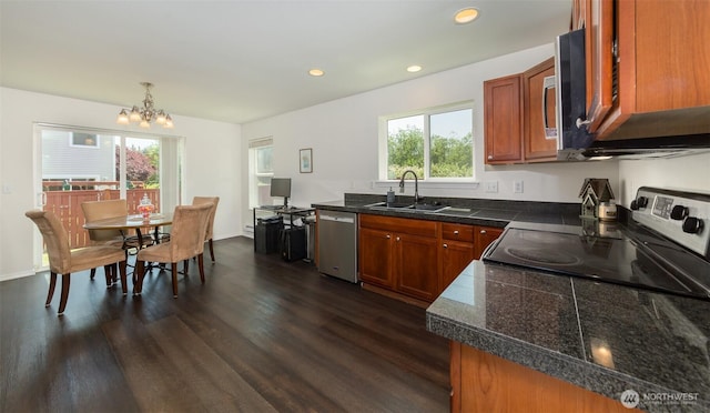 10312 26th Pl SE, Lake Stevens, WA 98258 - kitchen with tile counters, stainless steel appliances, dark wood-type flooring, a chandelier, and brown cabinets