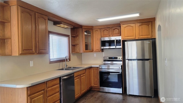 1618 112th St S, Parkland, WA 98444 - kitchen with stainless steel appliances, open shelves, brown cabinets, and dark wood-style floors