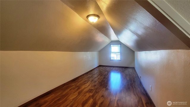 1618 112th St S, Parkland, WA 98444 - additional living space featuring dark wood-style flooring, vaulted ceiling, a textured ceiling, and a textured wall