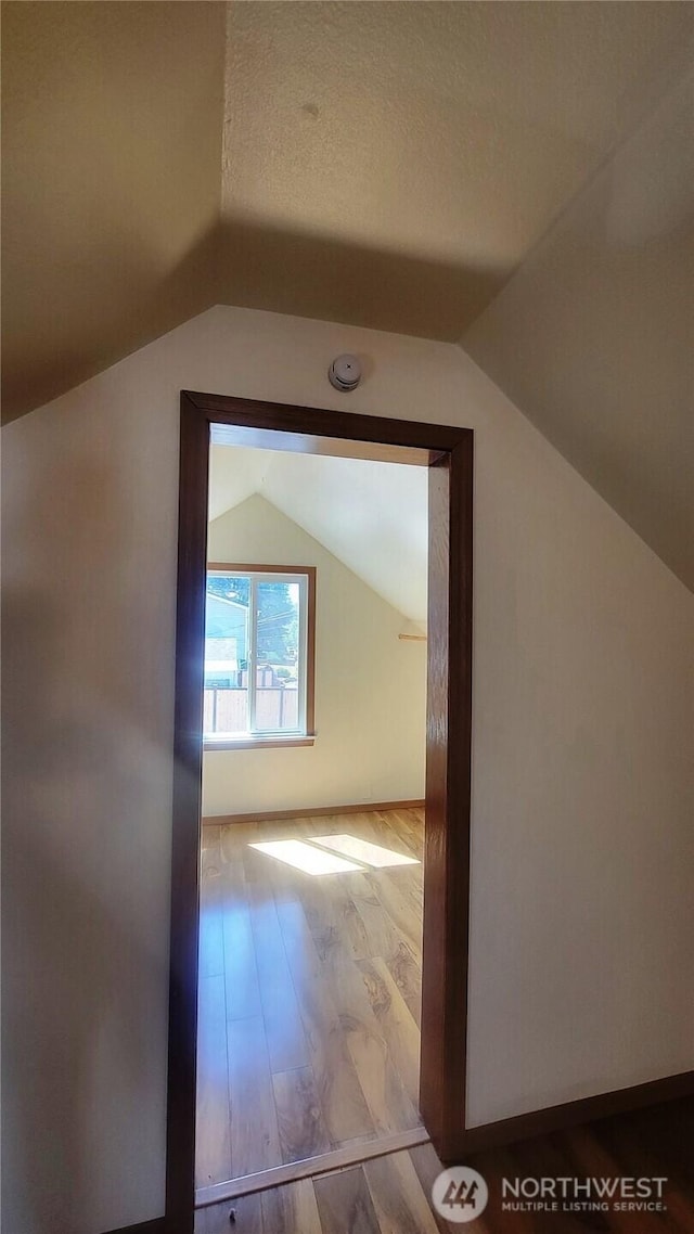 1618 112th St S, Parkland, WA 98444 - additional living space with lofted ceiling, wood finished floors, and a textured ceiling