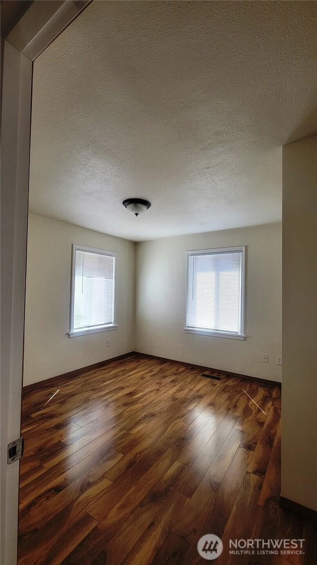 1618 112th St S, Parkland, WA 98444 - empty room with a textured ceiling, healthy amount of natural light, and hardwood / wood-style floors
