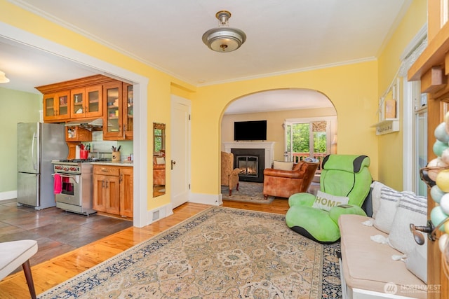 1833 3rd Ave, Kirkland, WA 98033 - living area featuring a glass covered fireplace, arched walkways, ornamental molding, and wood finished floors
