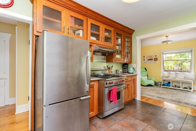 1833 3rd Ave, Kirkland, WA 98033 - kitchen with stainless steel appliances, under cabinet range hood, brown cabinets, and glass insert cabinets