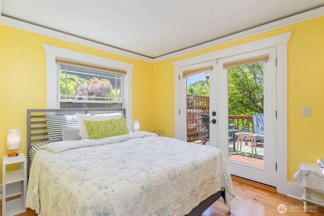 1833 3rd Ave, Kirkland, WA 98033 - bedroom featuring multiple windows, french doors, access to exterior, wood finished floors, and ornamental molding