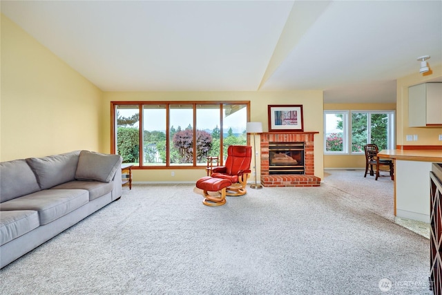 20135 Bue Rund Loop NE, Poulsbo, WA 98370 - living area with lofted ceiling, carpet, a brick fireplace, and baseboards