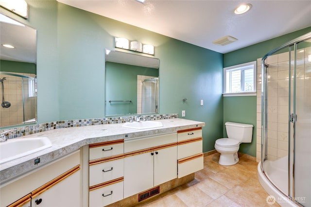 20135 Bue Rund Loop NE, Poulsbo, WA 98370 - bathroom featuring a shower stall, double vanity, toilet, tile patterned floors, and recessed lighting