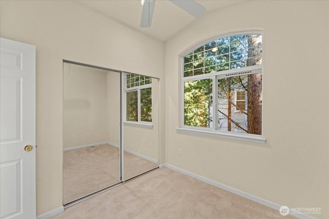 1980 132nd Ave SE Unit 40, Bellevue, WA 98005 - unfurnished bedroom with carpet floors, a closet, baseboards, and a ceiling fan