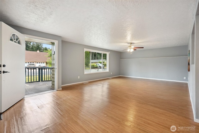 6836 Husky Way SE, Olympia, WA 98503 - unfurnished room featuring ceiling fan, wood finished floors, and a textured ceiling