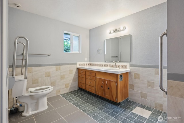 6836 Husky Way SE, Olympia, WA 98503 - bathroom featuring tile walls, tile patterned floors, vanity, and wainscoting