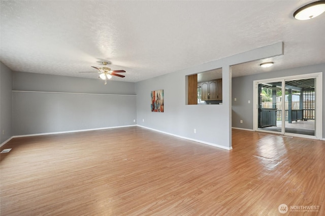 6836 Husky Way SE, Olympia, WA 98503 - empty room with a textured ceiling, light wood-type flooring, and a ceiling fan