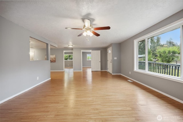 6836 Husky Way SE, Olympia, WA 98503 - unfurnished room featuring light wood-type flooring, ceiling fan, and a textured ceiling