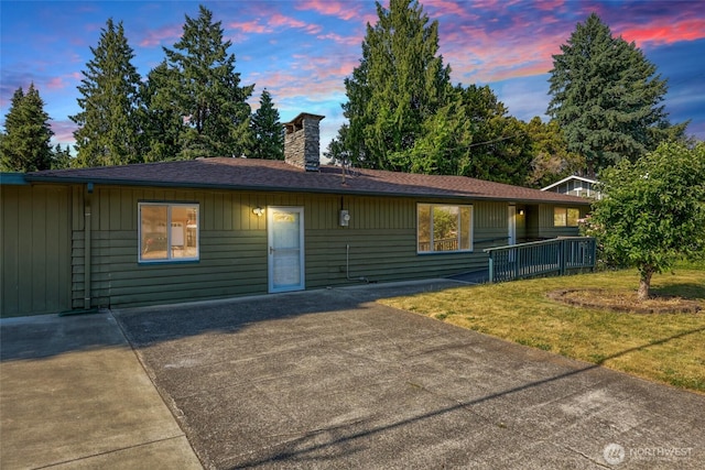 6836 Husky Way SE, Olympia, WA 98503 - ranch-style house with a chimney, a front yard, a patio area, and roof with shingles