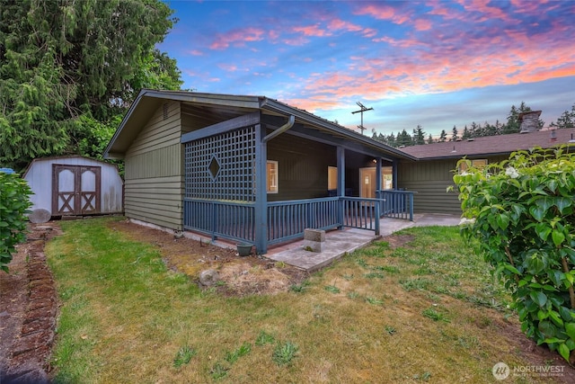 6836 Husky Way SE, Olympia, WA 98503 - view of side of home with a storage shed, a lawn, and covered porch
