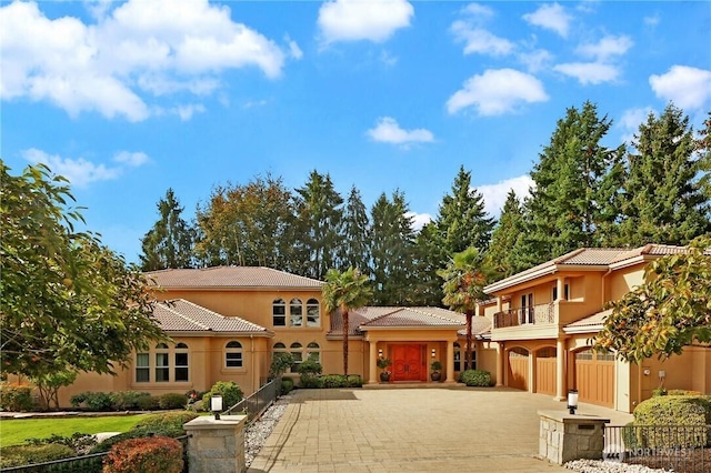 1055 91st Ave NE, Bellevue, WA 98004 - mediterranean / spanish house featuring a tiled roof, driveway, stucco siding, and a balcony
