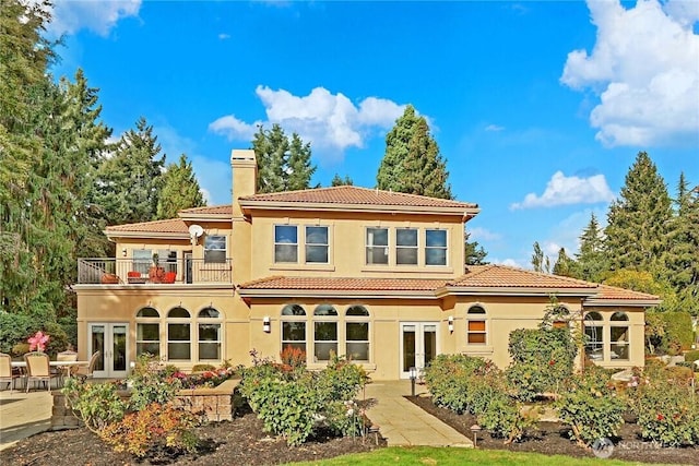 1055 91st Ave NE, Bellevue, WA 98004 - back of house featuring french doors, a balcony, a chimney, and stucco siding