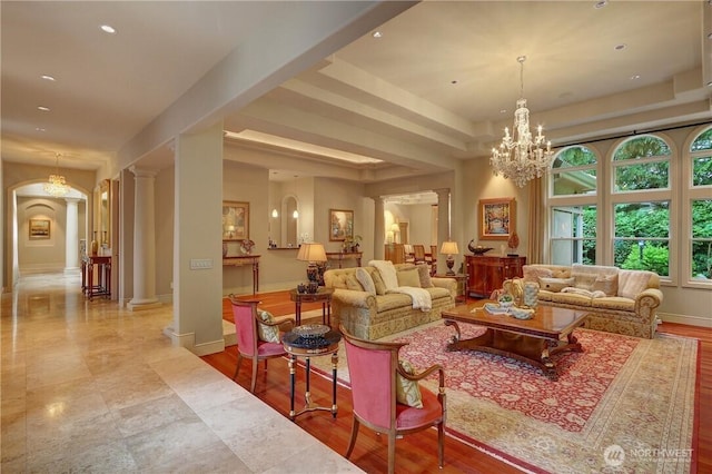 1055 91st Ave NE, Bellevue, WA 98004 - living room featuring ornate columns, a raised ceiling, recessed lighting, baseboards, and arched walkways