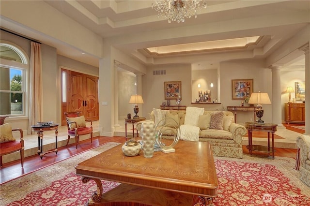 1055 91st Ave NE, Bellevue, WA 98004 - living area featuring a raised ceiling, ornate columns, wood finished floors, and a chandelier