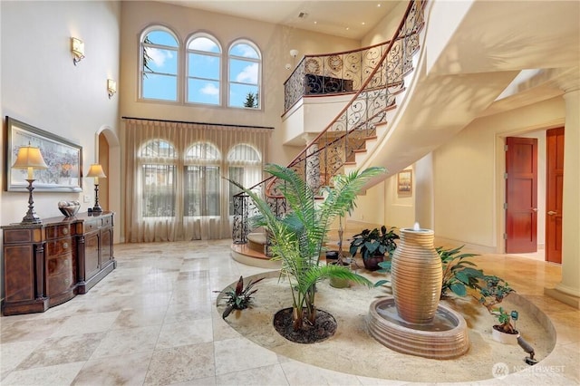 1055 91st Ave NE, Bellevue, WA 98004 - foyer entrance featuring a high ceiling, stairway, and arched walkways
