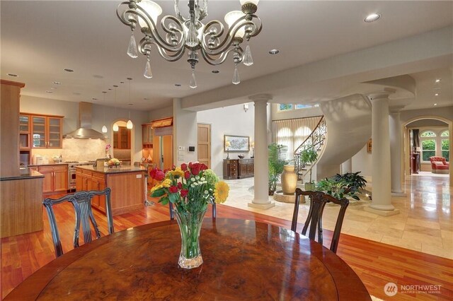 1055 91st Ave NE, Bellevue, WA 98004 - dining space featuring ornate columns, healthy amount of natural light, a chandelier, and recessed lighting