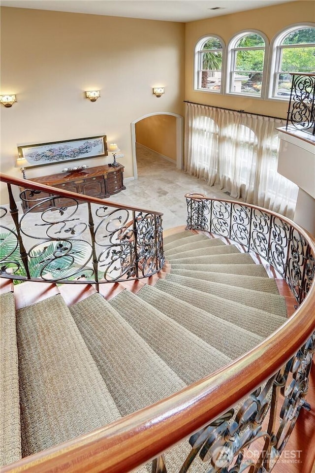 1055 91st Ave NE, Bellevue, WA 98004 - staircase featuring arched walkways and baseboards
