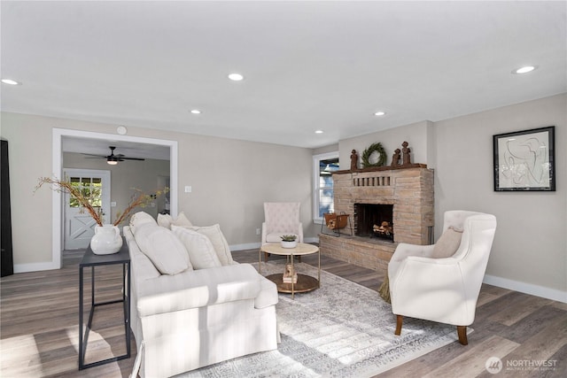 1106 Starling St, Steilacoom, WA 98388 - living room featuring baseboards, a fireplace with raised hearth, plenty of natural light, wood finished floors, and recessed lighting