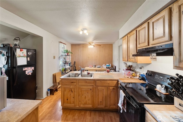 414 S Main, Mccleary, WA 98557 - kitchen with black appliances, under cabinet range hood, a sink, a peninsula, and light countertops