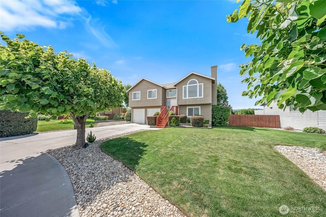 2427 Bellanca Ct, East Wenatchee, WA 98802 - view of front of house featuring an attached garage, concrete driveway, and a chimney
