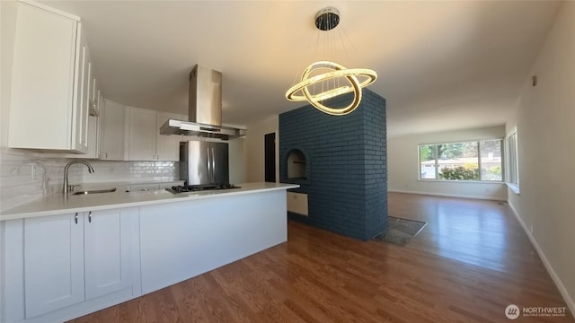 30022 2nd Pl SW, Federal Way, WA 98032 - kitchen featuring exhaust hood, dark wood finished floors, freestanding refrigerator, a peninsula, and tasteful backsplash