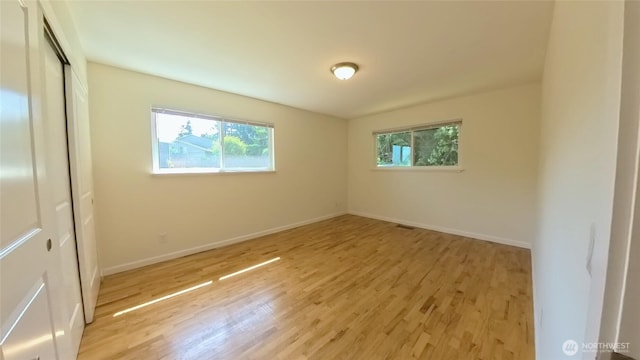 30022 2nd Pl SW, Federal Way, WA 98032 - unfurnished bedroom with multiple windows, light wood-type flooring, and a closet
