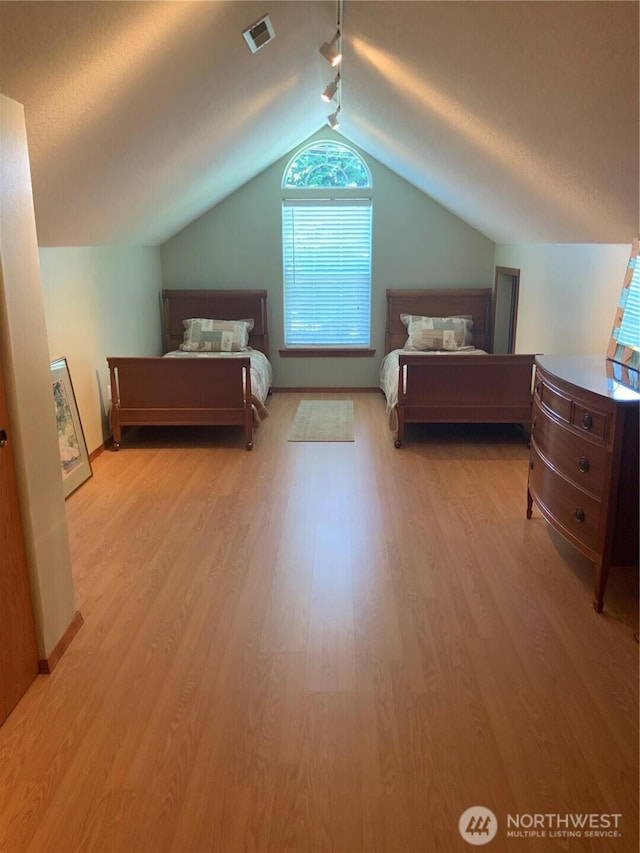3328 Pennsylvania, Longview, WA 98632 - bedroom with rail lighting, wood finished floors, and lofted ceiling