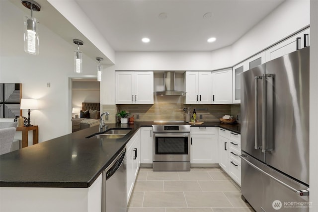 5450 Leary Ave NW Unit 251, Seattle, WA 98107 - kitchen featuring stainless steel appliances, wall chimney exhaust hood, a sink, a peninsula, and dark countertops