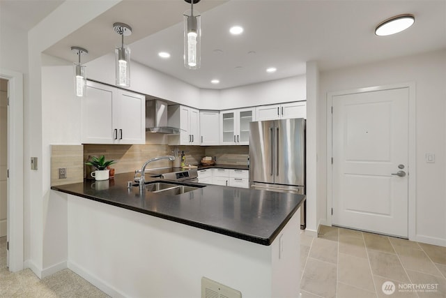 5450 Leary Ave NW Unit 251, Seattle, WA 98107 - kitchen with freestanding refrigerator, a sink, wall chimney exhaust hood, a peninsula, and glass insert cabinets