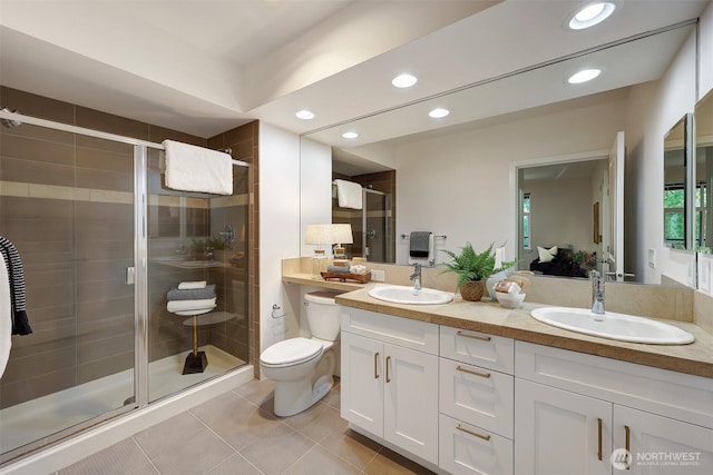 5450 Leary Ave NW Unit 251, Seattle, WA 98107 - full bathroom with recessed lighting, double vanity, toilet, a shower stall, and tile patterned floors