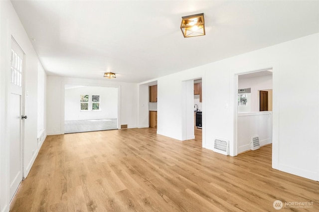 449 NE Cliff Ave, Wilbur, WA 99185 - unfurnished living room featuring light wood-style flooring, baseboards, and a sink