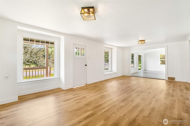 449 NE Cliff Ave, Wilbur, WA 99185 - unfurnished living room with healthy amount of natural light, light wood-style flooring, and baseboards