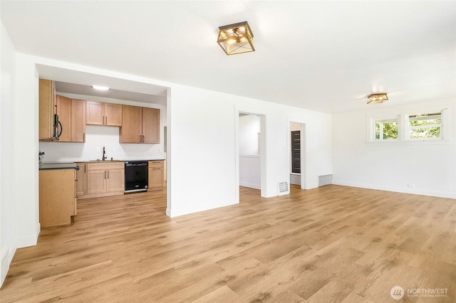 449 NE Cliff Ave, Wilbur, WA 99185 - unfurnished living room featuring a sink, light wood-style floors, and baseboards