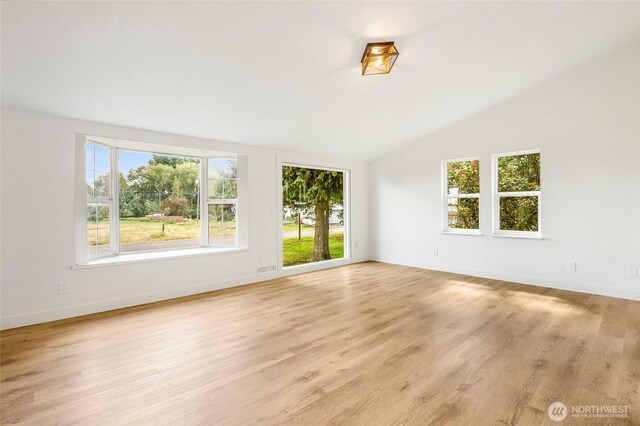 449 NE Cliff Ave, Wilbur, WA 99185 - unfurnished room featuring vaulted ceiling, baseboards, and light wood finished floors