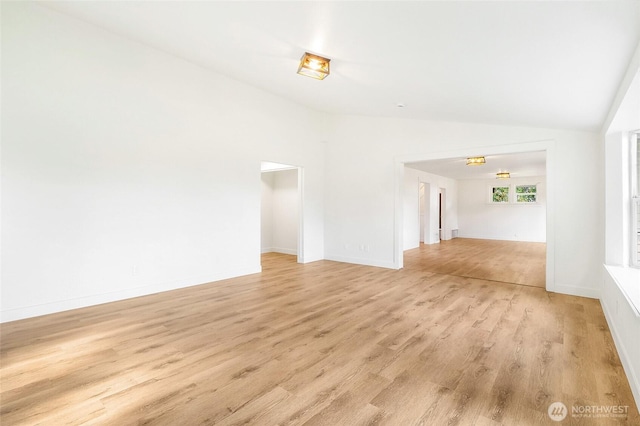 449 NE Cliff Ave, Wilbur, WA 99185 - unfurnished living room featuring light wood-type flooring, vaulted ceiling, baseboards, and a chandelier