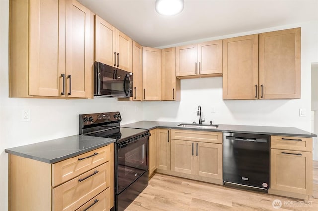 449 NE Cliff Ave, Wilbur, WA 99185 - kitchen featuring black appliances, a sink, light brown cabinetry, light wood finished floors, and dark countertops