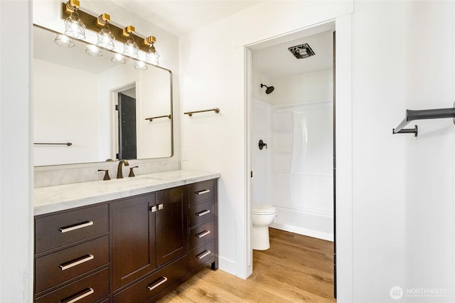 449 NE Cliff Ave, Wilbur, WA 99185 - full bathroom with wood finished floors, toilet, vanity, and baseboards