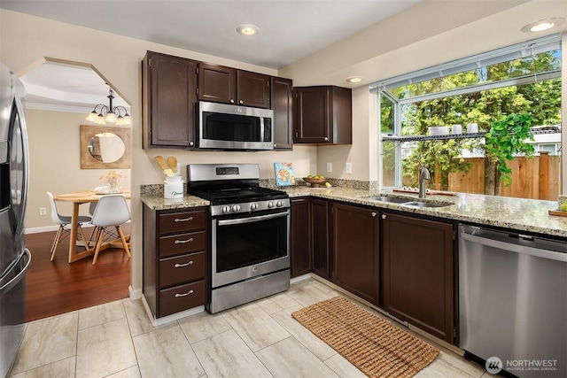 600 213th St SW, Bothell, WA 98021 - kitchen featuring appliances with stainless steel finishes, light stone countertops, dark brown cabinetry, and recessed lighting