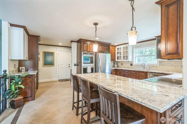 804 S Park Ct, Lynden, WA 98264 - kitchen featuring stainless steel appliances, a peninsula, backsplash, light stone counters, and a breakfast bar