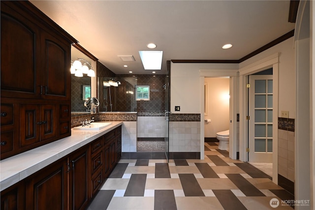 804 S Park Ct, Lynden, WA 98264 - bathroom with a shower stall, crown molding, a skylight, vanity, and tile walls